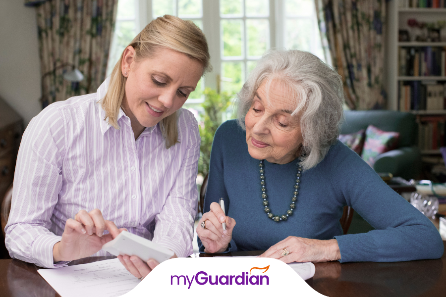 a carer explaining a paper to a elderly client